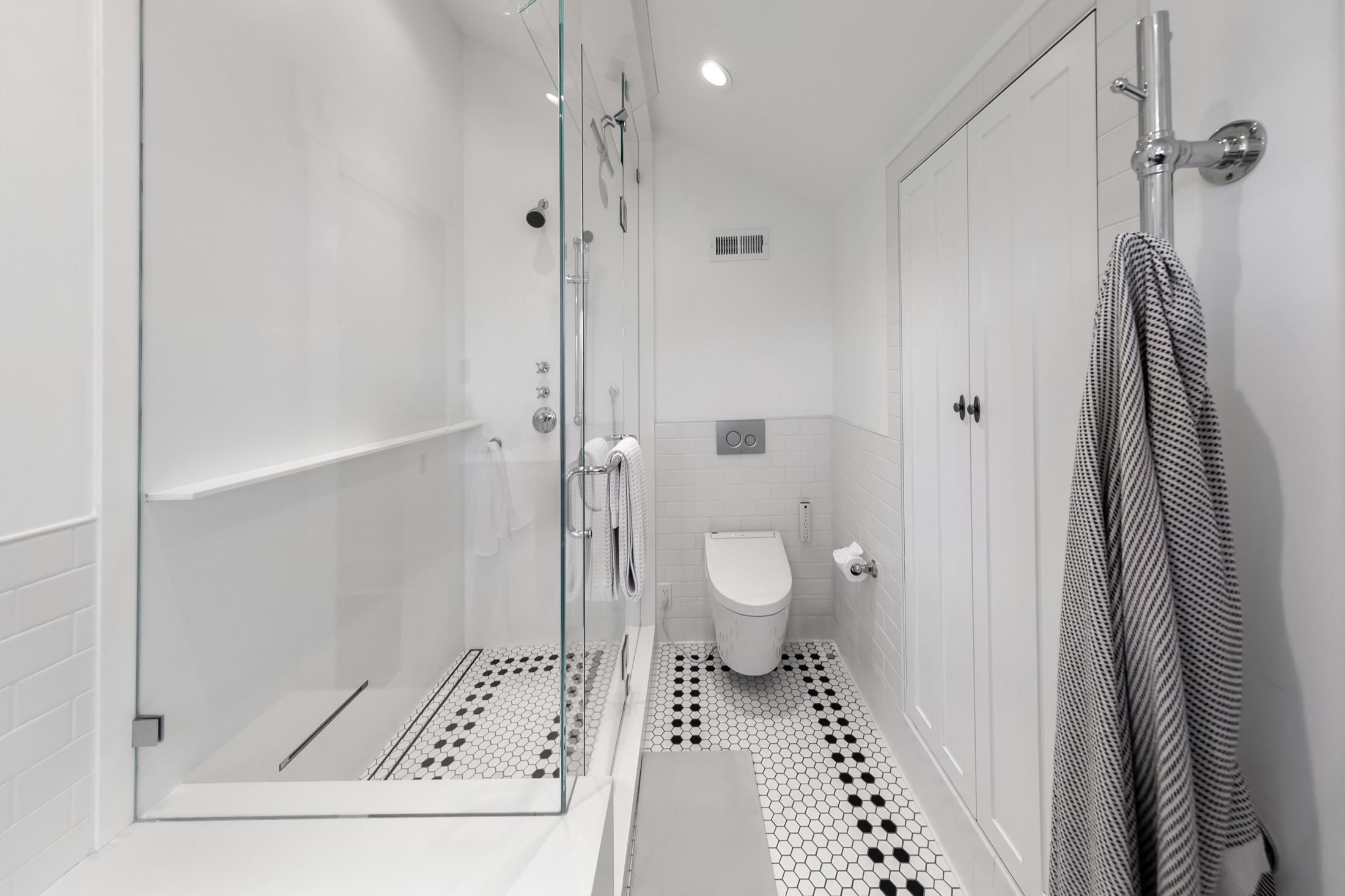 Primary bathroom with glass steam shower and patterned floor tile
