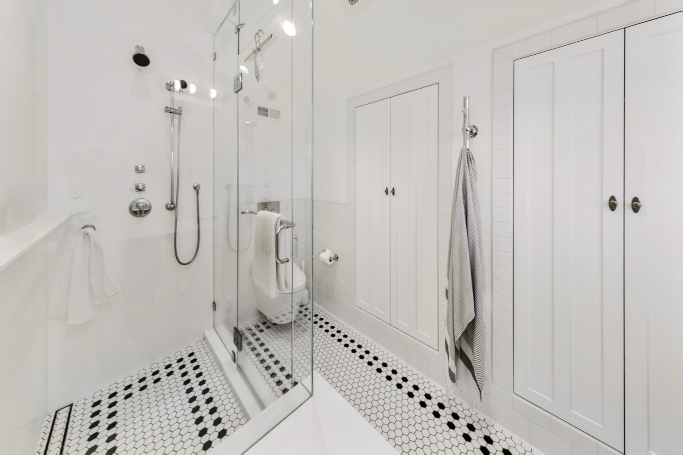 Glass steam shower with custom tile and fixtures