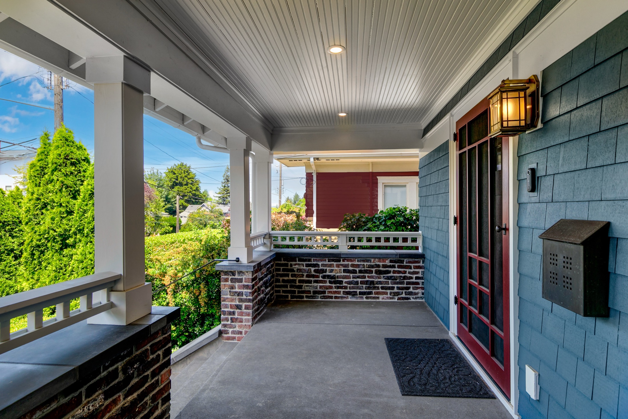Front porch with custom columns, trim, and reclaimed brick