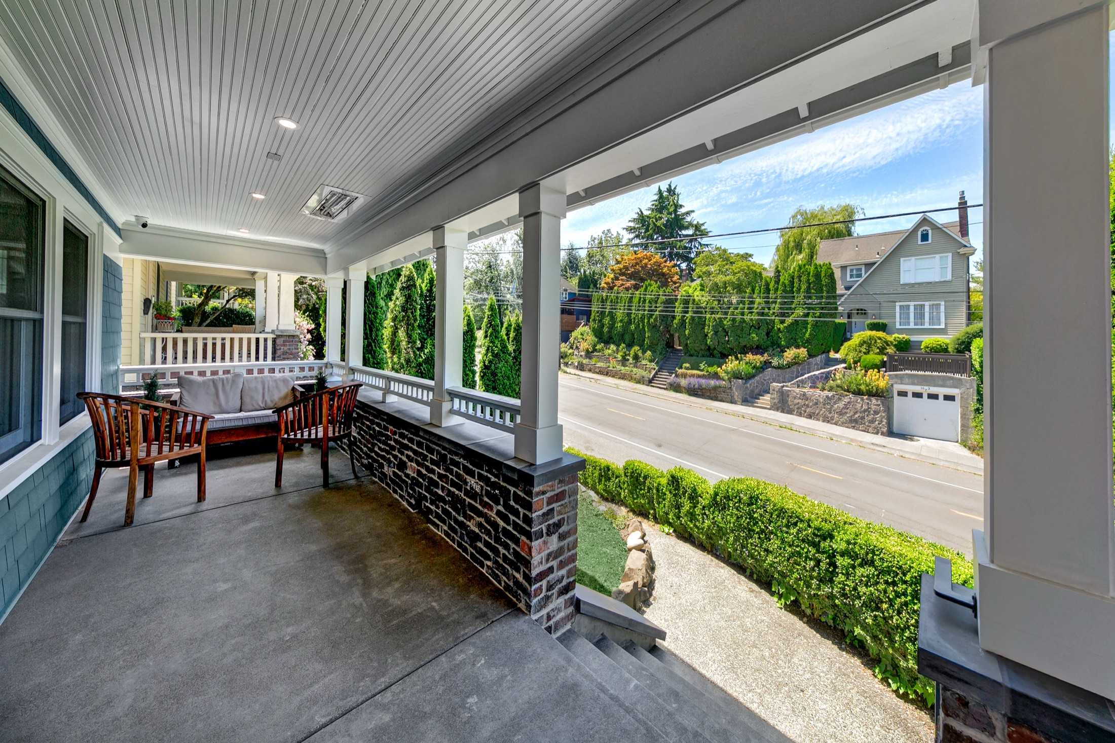 Covered front porch with seating and neighborhood view