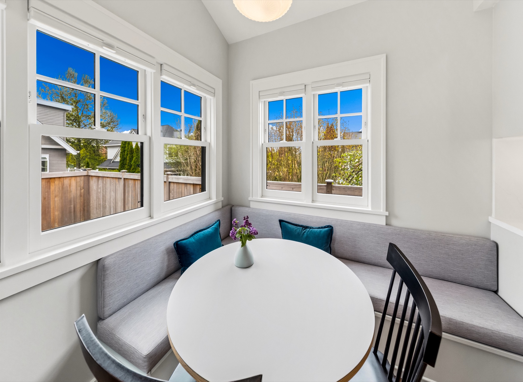 Round breakfast table with cushioned window bench