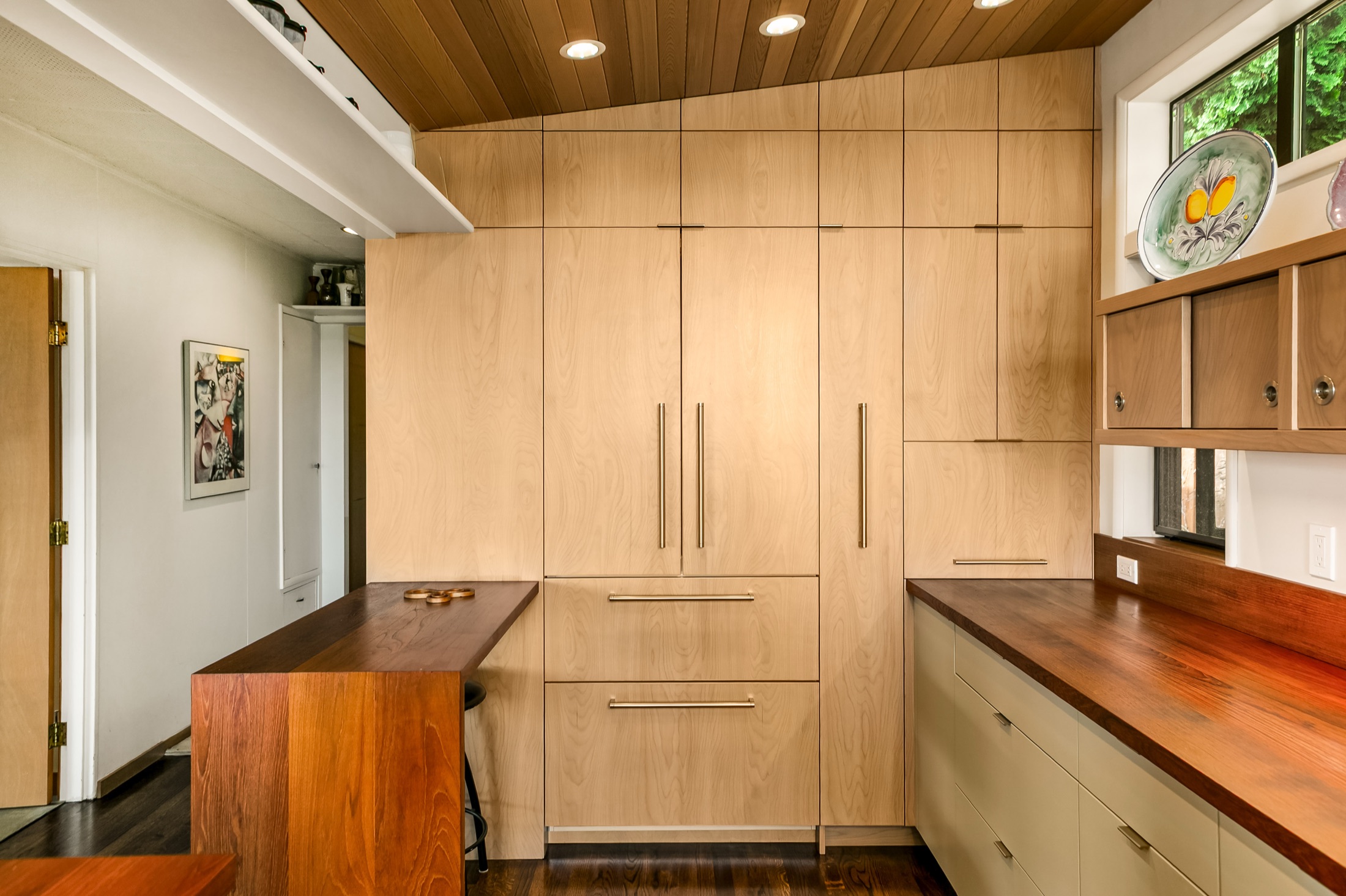 Full-height custom pantry cabinetry and wood peninsula